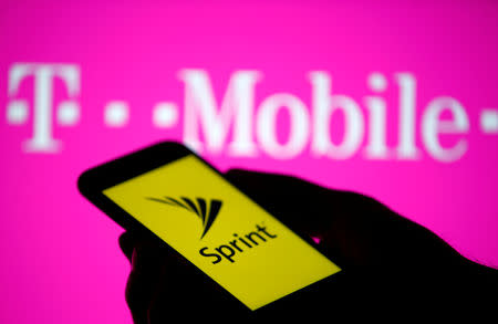 FILE PHOTO: A smartphone with Sprint logo are seen in front of a screen projection of T-mobile logo, in this picture illustration taken April 30, 2018. REUTERS/Dado Ruvic/Illustration