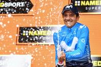 Richard Carapaz celebrates on the podium after winning the 14th stage of the Giro d'Italia cycling race, from Saint-Vincent to Courmayeur, Saturday, May 25, 2019. Richard Carapaz of Ecuador won the grueling 14th stage of the Giro d'Italia on Saturday to move into the overall lead. (Alessandro Di Meo/ANSA via AP)