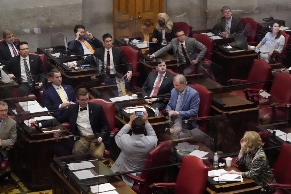 Members of the Tennessee House of Representatives cast their votes and watch the tally board as they vote on a bill allowing most adults to carry handguns without obtaining a permit Monday, March 29, 2021, in Nashville, Tenn. The bill passed the House, 64-29, and can now be signed into law by Gov. Bill Lee. (AP Photo/Mark Humphrey)