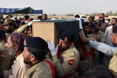 Army soldiers carry the casket of Siraj Raisani, provincial assembly candidate of Baluchistan Awami Party (BAP), who was killed in FridayÕs suicide attack during an election campaign meeting, for the funeral in Quetta, Pakistan July 14, 2018. REUTERS/Naseer Ahmed