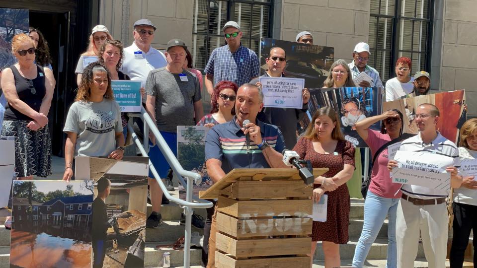 Joe Mangino, president and cofounder of the New Jersey Organizing Project, whose Stafford home was damaged in Superstorm Sandy, addresses a crowd of people outside the Statehouse in Trenton on June 1, 2023.