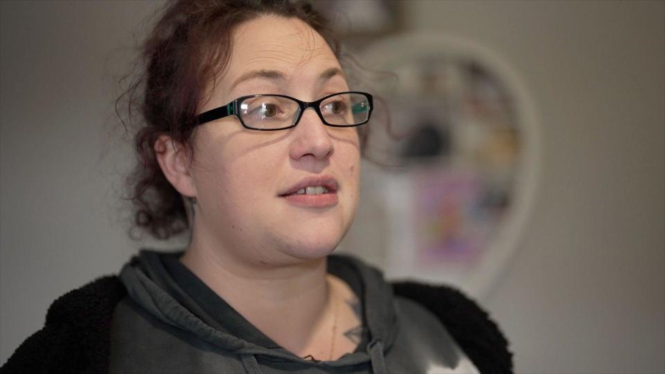 Gemma, a young woman in a hoodie and wearing glasses, who said Depher used her image and falsely accused her of theft