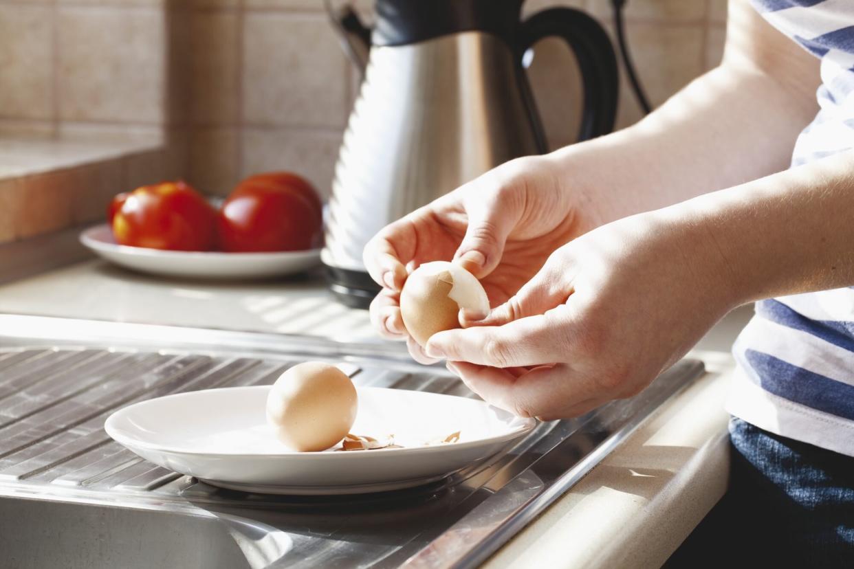 Peeling hard boiled eggs by window