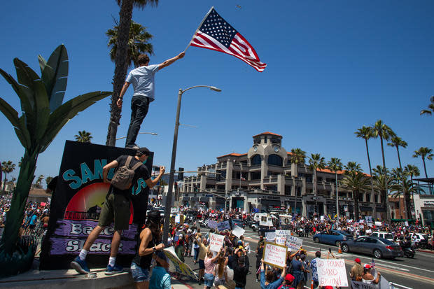 Protest To Reopen California Businesses, Beaches, And Parks Held In Huntington Beach 