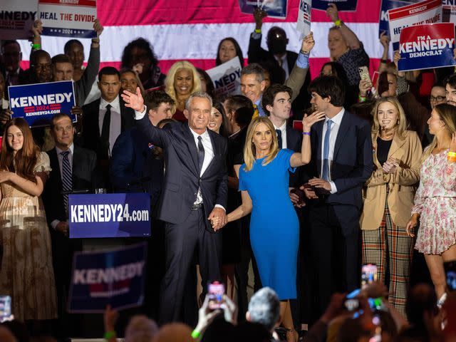 <p>Scott Eisen/Getty</p> Robert F. Kennedy Jr. and Cheryl Hines wave to supporters on stage after announcing his candidacy for president on April 2023.