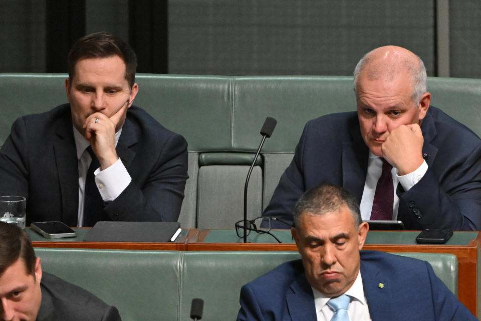 Liberal member and longtime Morrison ally Alex Hawke sits on the backbench alongside the former PM. Source: AAP