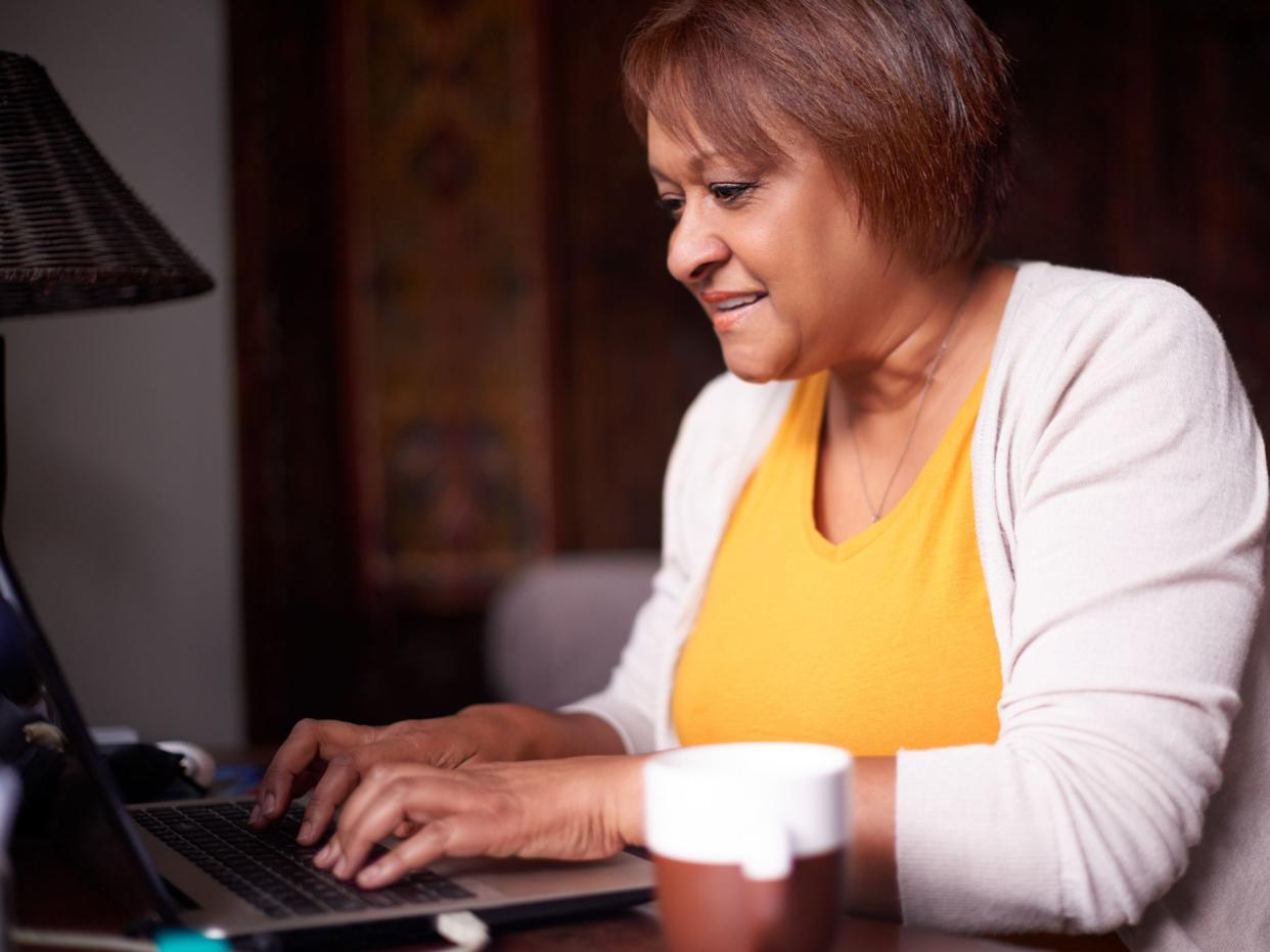 Shot of a mature woman using a laptop at home