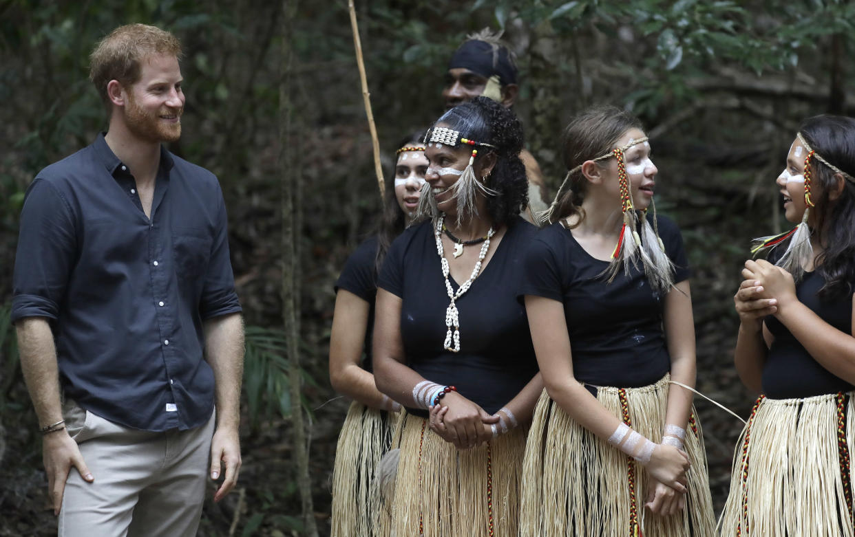 Britain's Prince Harry meets local dancers after the unveiling of the Queens Commonwealth Canopy at Pile Valley, K'gari during a visit to Fraser Island, Australia, Monday, Oct. 22, 2018. Prince Harry and his wife Meghan are on day seven of their 16-day tour of Australia and the South Pacific. (AP Photo/Kirsty Wigglesworth)