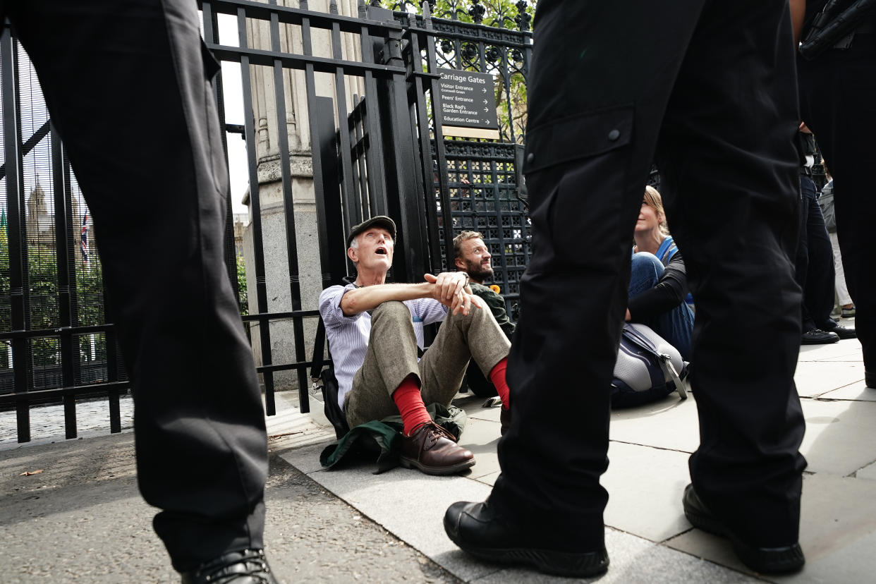 Extinction Rebellion protesters, who have padlocked their necks to the railings, outside the Houses of Parliament, Westminster, calling for a Citizen's assembly. The campaign group says supporters have also superglued themselves around the Speaker's chair in the House of Commons chamber. Picture date: Friday September 2, 2022.