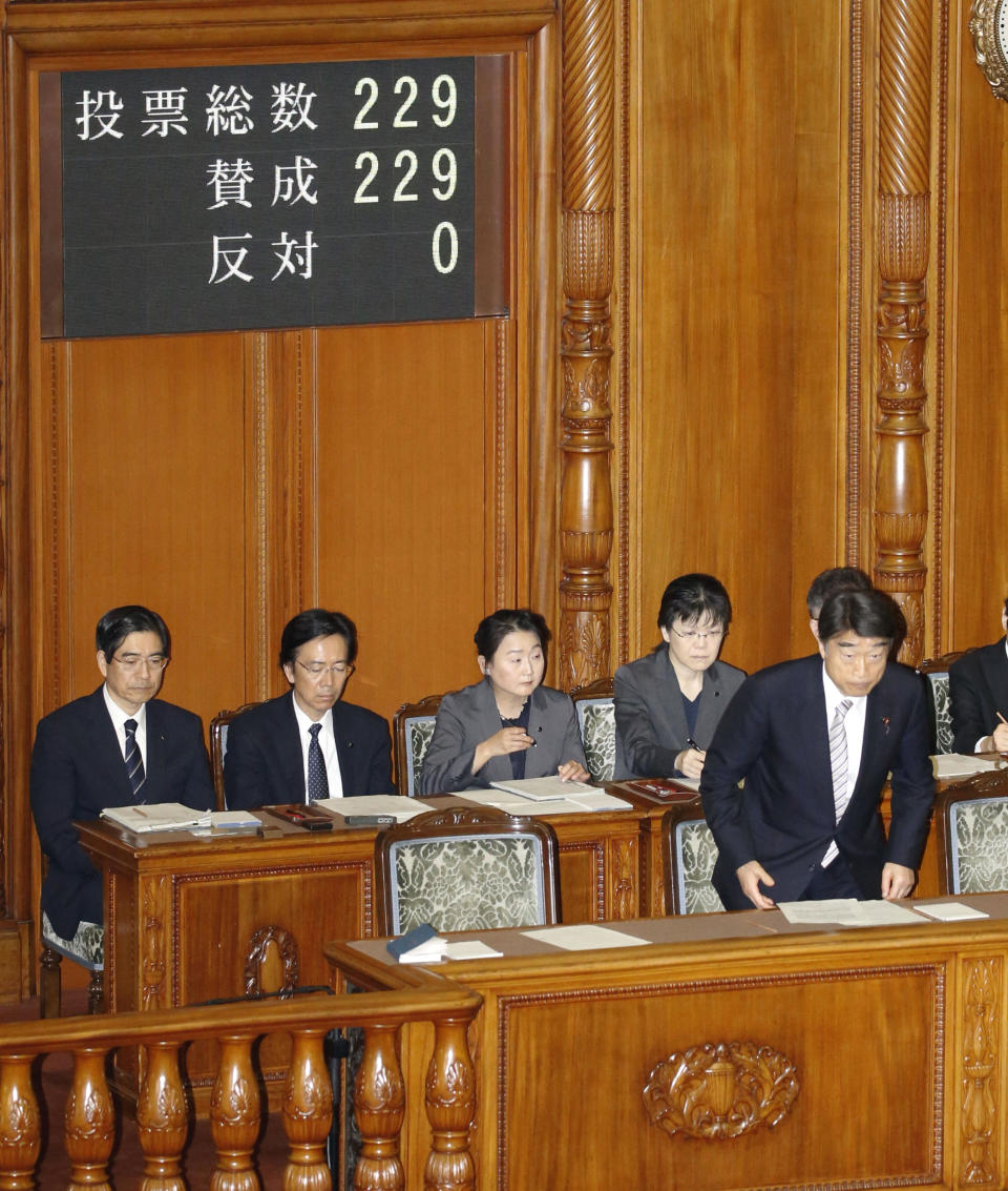 Health, Welfare and Labor Minister Takumi Nemoto, right, bows after Eugenics Protection Law was passed at parliament's upper house in Tokyo Wednesday, April 25, 2019. Japan's government apologized to tens of thousands of victims forcibly sterilized under the now-defunct Eugenics Protection Law and promised to pay compensation. (Toshiyuki Matsumoto/Kyodo News via AP)