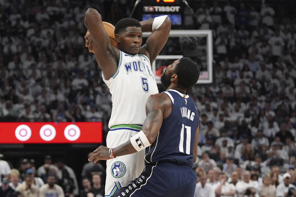 Minnesota Timberwolves guard Anthony Edwards (5) looks to pass over Dallas Mavericks guard Kyrie Irving (11) during the second half in Game 1 of the NBA basketball Western Conference finals, Wednesday, May 22, 2024, in Minneapolis. (AP Photo/Abbie Parr)