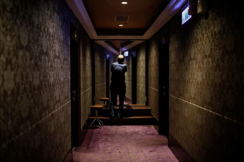 Deputy general manager Wang Zhe Qian, 64, opens the door to an empty massage room as Taiwan's entry restrictions to foreign travellers due to the coronavirus disease (COVID-19) continues to affect business at Dynasty massage parlour in Taipei