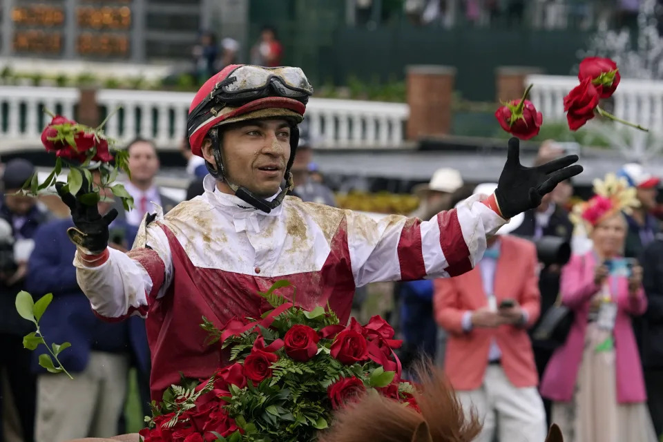 Jockey Sonny Leon tosses roses into the air in the winner&#39;s circle after winning the 148th running of the Kentucky Derby horse race at Churchill Downs Saturday, May 7, 2022, in Louisville, Ky. (AP Photo/Brynn Anderson)