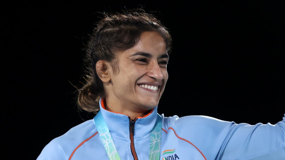 Vinesh Phogat receives a gold medal at the 2022 Commonwealth Games