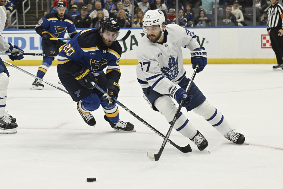 Toronto Maple Leafs' Timothy Liljegren (37) works the puck against St. Louis Blues' Brandon Saad (20) during the second period of an NHL hockey game Monday, Feb. 19, 2024, in St. Louis. (AP Photo/Michael Thomas)