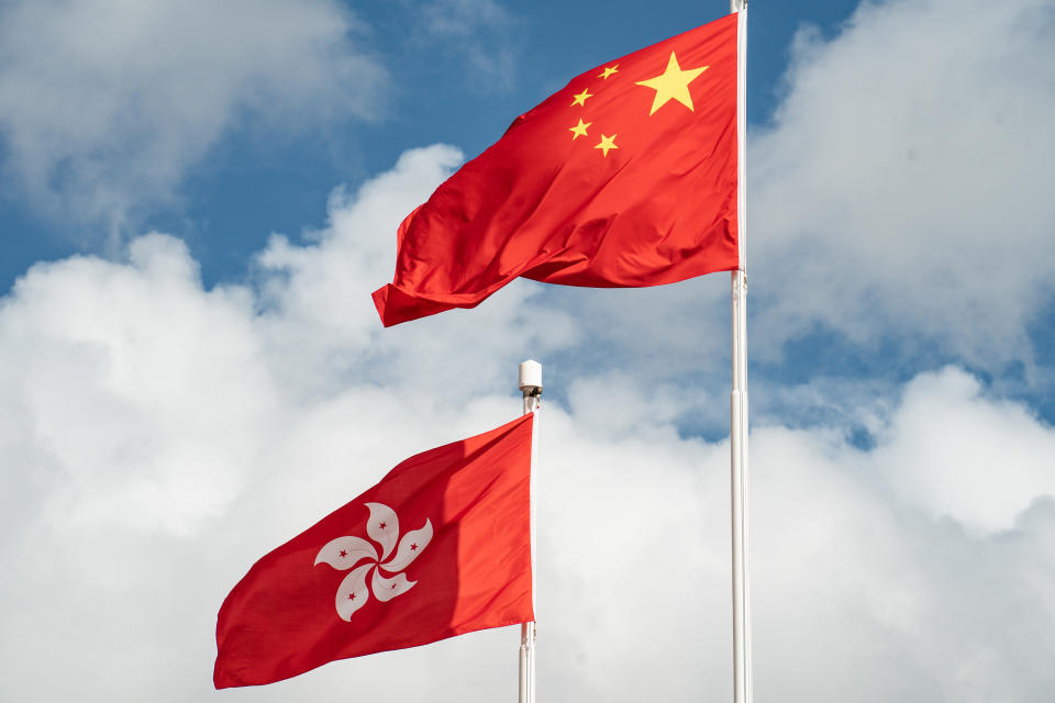 HONG KONG, CHINA - JULY 01: The flags of China and the Hong Kong Special Administrative Region fly after a flag-raising ceremony at Golden Bauhinia Square on July 1, 2020 in Hong Kong, China. Hong Kong marks the 23rd anniversary of its handover to China on July 1 after Beijing imposed the new national security law. (Photo by Anthony Kwan/Getty Images)