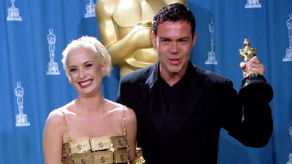 Australians Lizzy Gardiner and Tim Chappel hold the Oscars they received for best costume design for their work in the film "The Adventures of Priscilla: Queen of the Desert" at the 67th annual Academy Awards March 27 in Los Angeles. Gardiner's gown is made of American Express credit cards - Blake Sell/Reuters