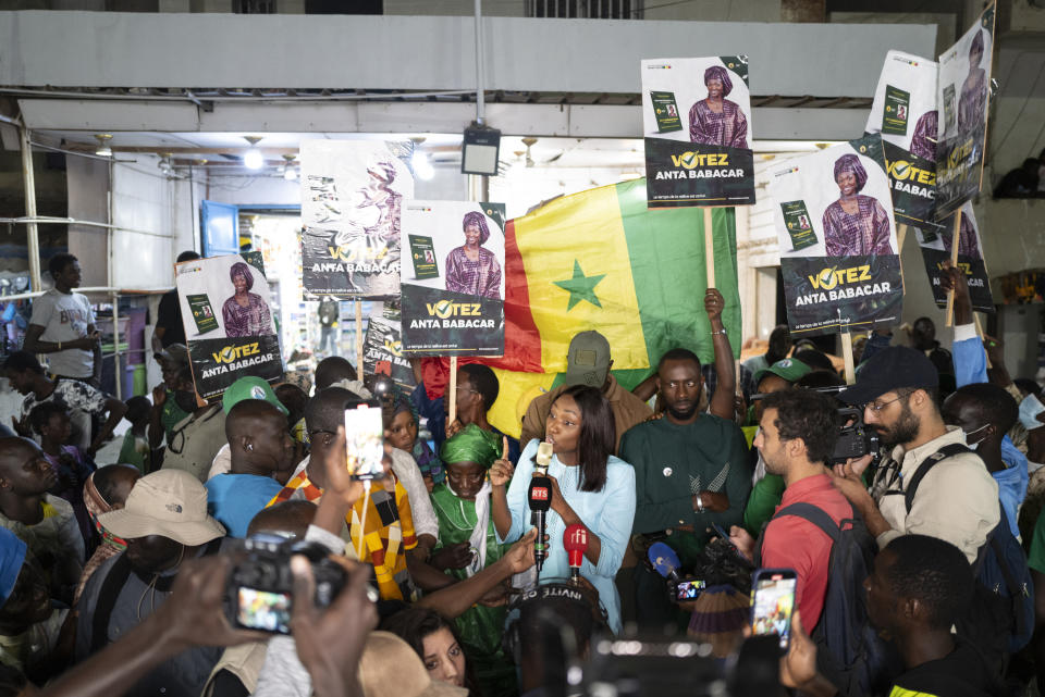 Presidential candidate Anta Babacar Ngom greets supporters during her electoral campaign caravan in Dakar, Senegal, Monday, March 11, 2024. Senegal’s only female presidential candidate may stand no chance of winning but activists say her presence alone is helping to advance a decades long campaign to achieve equality in the West African nation. (AP Photo/Sylvain Cherkaoui)