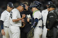 New York Yankees relief pitcher Wandy Peralta (58) is checked by a trainer during the third inning of Game 4 of an American League Championship baseball series against the Houston Astros, Sunday, Oct. 23, 2022, in New York. (AP Photo/Seth Wenig)