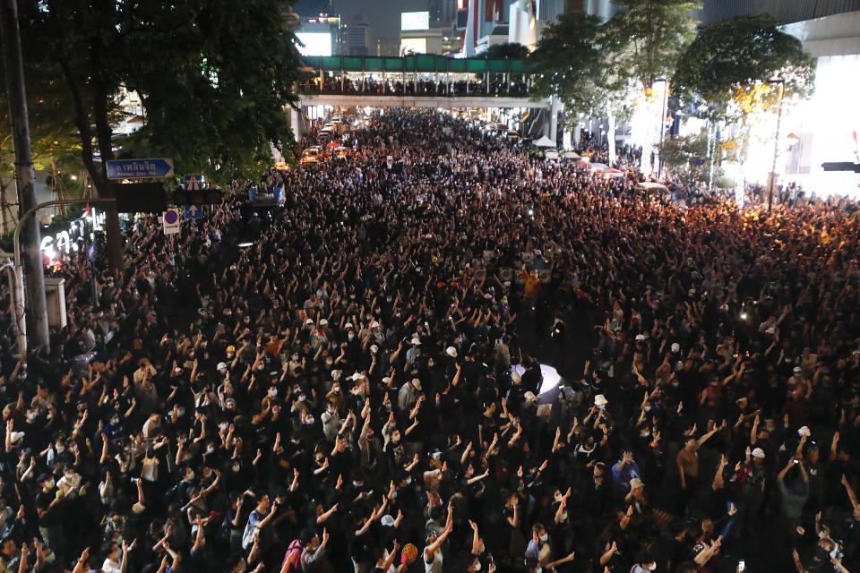 Pro-democracy protesters flash the three-finger protest salute during an anti-government rally in Bangkok, Thailand, Wednesday, Nov. 18, 2020. Police in Thailand's capital braced for possible trouble Wednesday, a day after a protest outside Parliament by pro-democracy demonstrators was marred by violence that left dozens of people injured. (AP Photo/Sakchai Lalit)