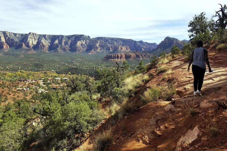 A visitor walks a trail in the Coconino national forest in Sedona, Arizona.