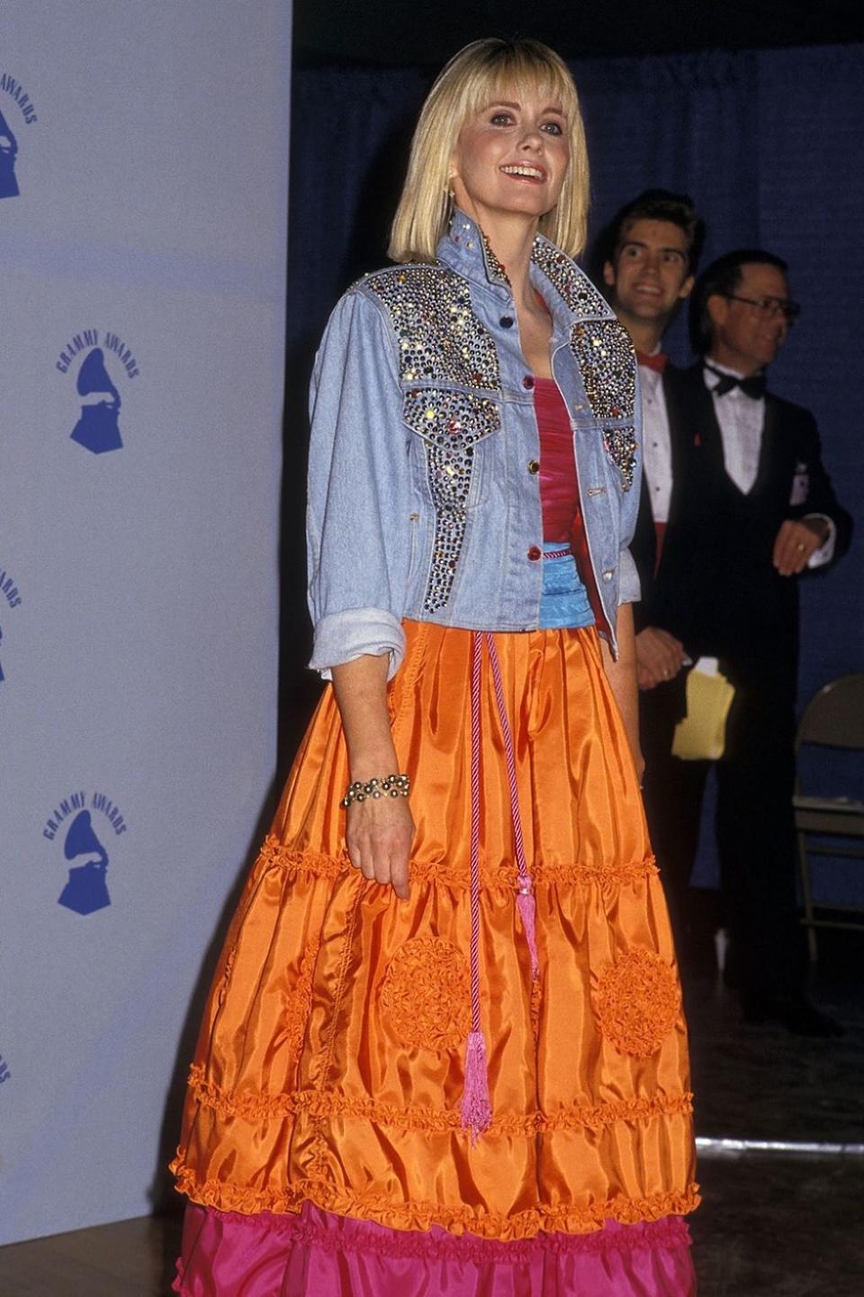 <p>I like to think ONJ spent the week before the Grammys sitting at home bedazzling that denim jacket herself. Just look at the expression on her face — that's pride in a handy craft well done.</p>