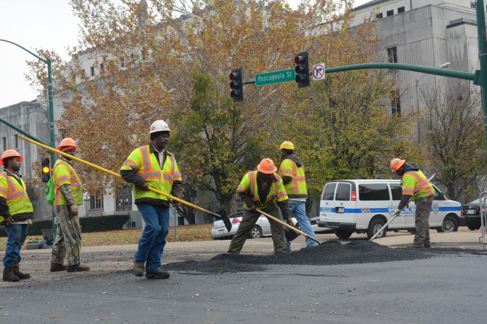 Jackson city workers repaving Pearl Street in downtown Jackson on Dec. 20, 2017. Many public employers, such as cities, counties, school districts and state agencies are facing heightened contributions into the Public Employment Retirement System of Employees, which could cause them to cut new jobs. State Lawmakers also intend to pass retirement reform this year to curb the issue, as well as decreasing public worker numbers.