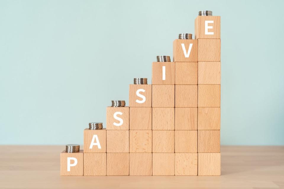 Stacks of wooden blocks arranged to show increasing growth, with the letters spelling passive on the first block of each stack.