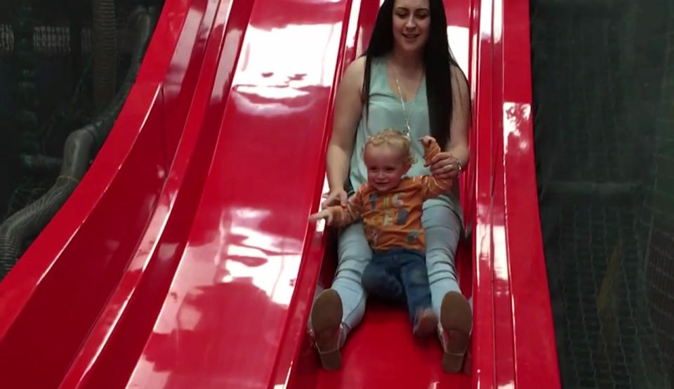 This is the horror moment a toddler’s leg snapped while his mum took him down a slide on her lap. Photo: Mega