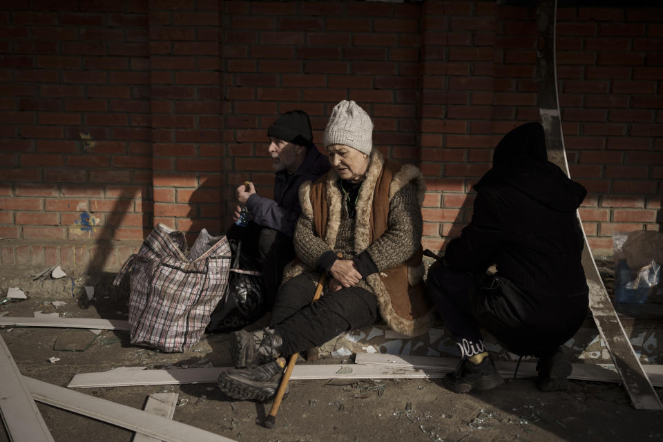 People fleeing the village of Ruska Lozova wait at a screening point in Kharkiv, Ukraine, Friday, April 29, 2022. Hundreds of residents have been evacuated to Kharkiv from the nearby village that had been under Russian occupation for more than a month. (AP Photo/Felipe Dana)