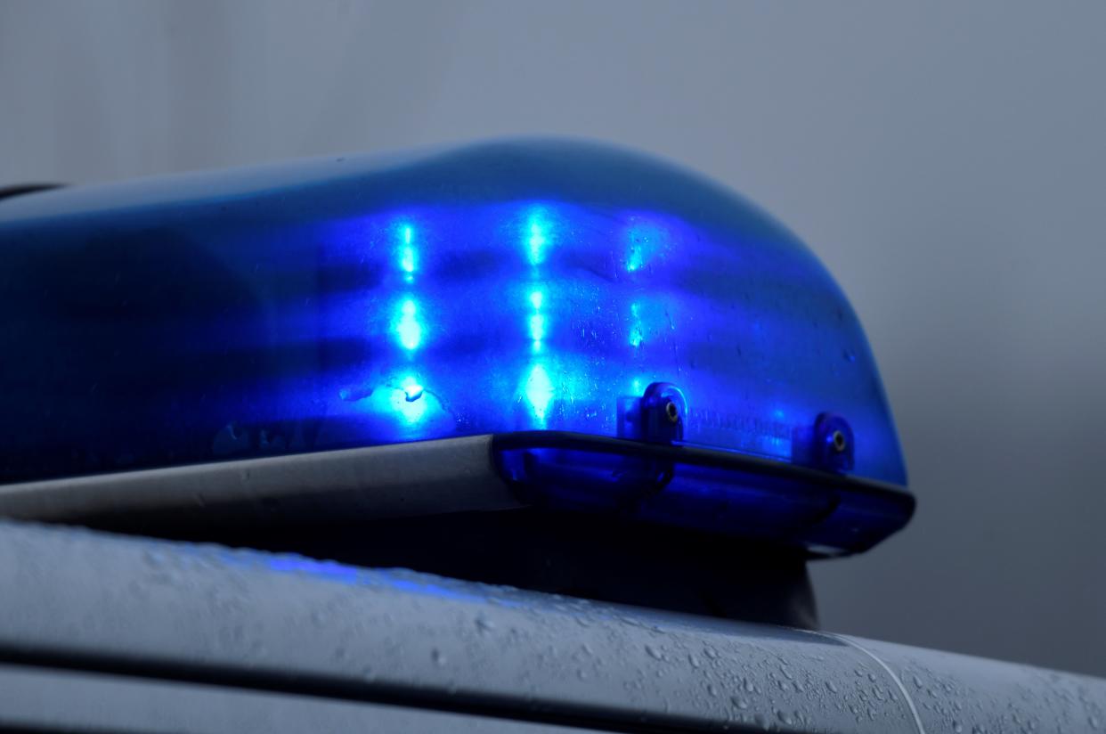 A flashing blue light of a police car.