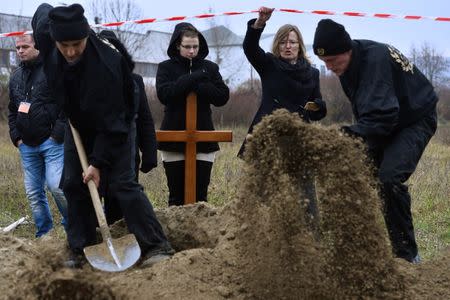 Gravediggers compete during a grave digging championship in Trencin, Slovakia, November 10, 2016, where eleven pairs of gravediggers are competing in digging based on accuracy, speed, and aesthetic quality. REUTERS/Radovan Stoklasa