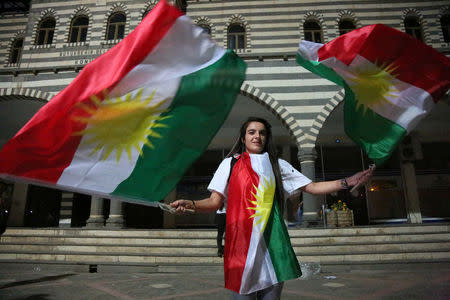 A woman waves Kurdish flags in Diyarbakir, Turkey, September 25, 2017. REUTERS/Sertac Kayar