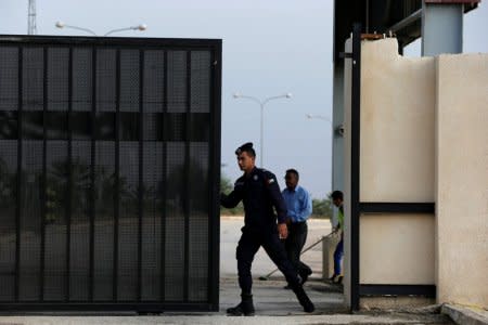 A Jordanian policeman opens the gate of Jordan's Jaber border crossing checkpoint near Syria's Nasib checkpoint, near Marfaq, Jordan, October 15, 2018. REUTERS/Muhammad Hamed