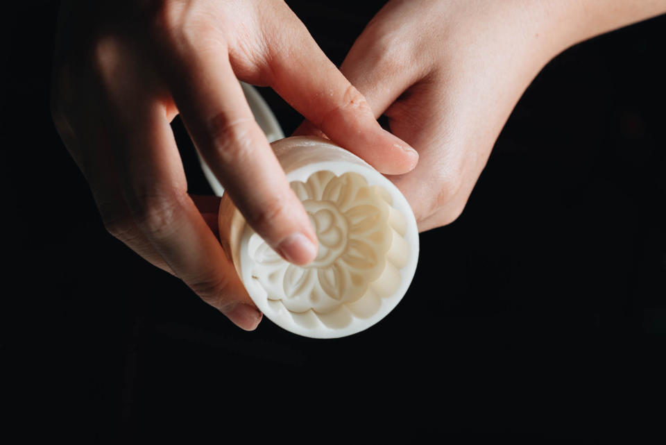 Zhu uses a plastic mooncake press like this one that lends the pastries a floral pattern. (Courtesy Maggie Zhu)