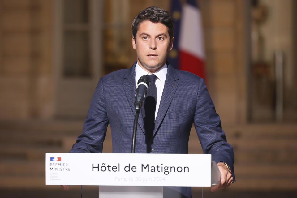 French Prime Minister Gabriel Attal delivers a speech in the courtyard of the Prime Minister's residence, Sunday, June 30, 2024 in Paris. France's high-stakes legislative elections propelled the far-right National Rally to a strong but not decisive lead in the first-round vote Sunday, polling agencies projected, dealing another slap to centrist President Emmanuel Macron. (AP Photo/Thomas Padilla)