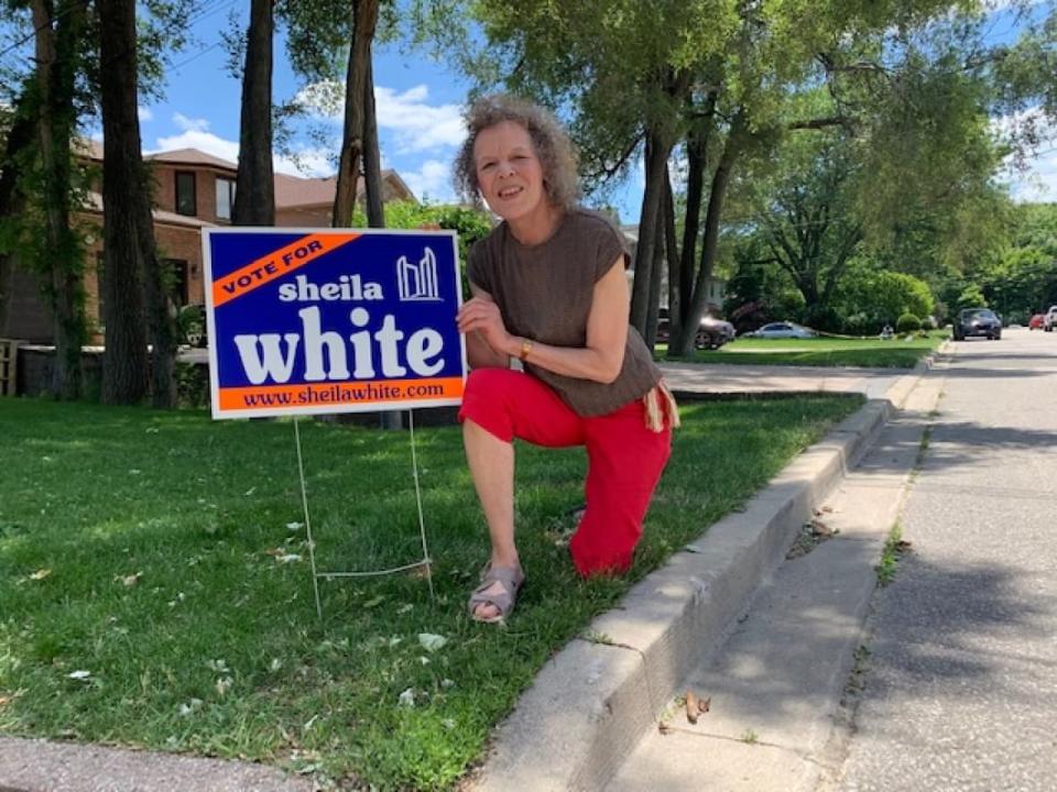 Long time political adviser Sheila White pictured here with a campaign sign from her 2000 run for city council. White says rookie campaigners should do everything they can to knock on as many doors as possible. (Mike Smee/CBC - image credit)