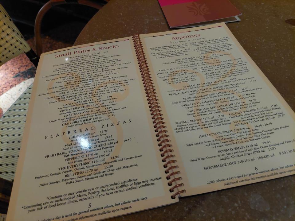 A photo of the Cheesecake Factory's menu. The page is open on small plates and appetizers