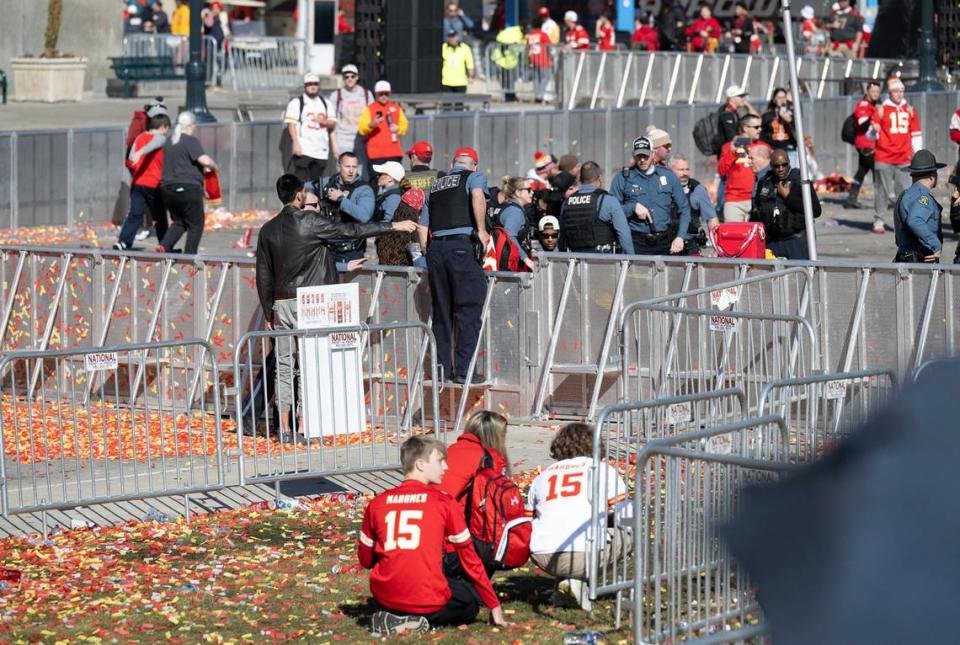 A group of teenagers crouch down after shots were fired at the Kansas City Chiefs Super Bowl LVIII championship rally on Wednesday, Feb. 14, at Union Station in Kansas City. One person was killed and more than 20 more people were injured when struck by gunfire during the mass shooting event.