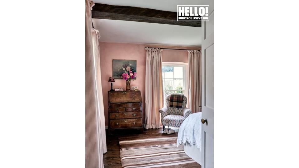 Penelope Chilvers' pink bedroom with striped carpet at Cotswolds home