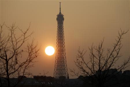 The Eiffel tower is pictured during sunset as warm and sunny weather continues in France, March 14, 2014. REUTERS/Charles Platiau
