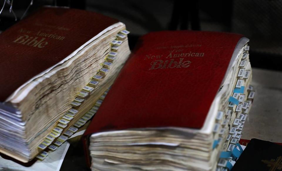 A pair of well-used Bibles belonging to Lillian and Ernesto Parra sit on the fireplace hearth of their temporary Pasco home. The damaged Bibles were among the very few personal items recovered from their fire-damaged home.