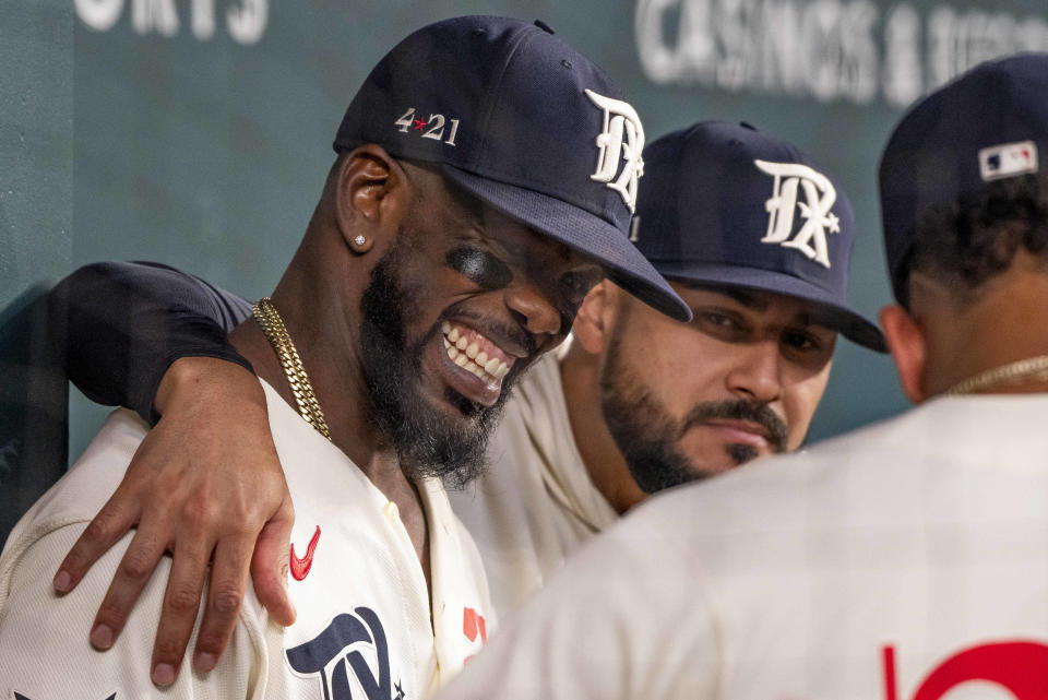 Texas Rangers' Adolis Garcia shares a laugh with teammates prior to the start of a baseball game against the Cleveland Guardians in Arlington, Texas, Saturday, July 15, 2023. (AP Photo/Emil T. Lippe)