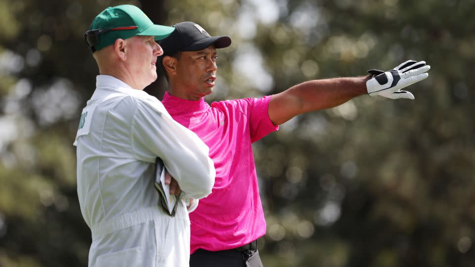 Tiger Woods and his caddie Joe LaCava line up a shot from the second hole during the first round of the Masters. - Jamie Squire/Getty Images