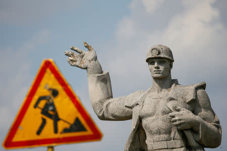 A statue to a miner is pictured next to a road in Novovolynsk, Ukraine August 2, 2018. Picture taken August 2, 2018. REUTERS/Valentyn Ogirenko