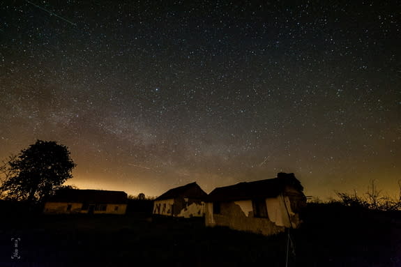 A Lyrid meteor is visible in the lower right portion of the image, above the nearest building, in this image taken in in Kocsér, Hungary. The other streaks in the image were created by airplanes.