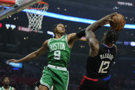 Boston Celtics guard Romeo Langford (9) defends against Los Angeles Clippers guard Eric Bledsoe (12) during the first half of an NBA basketball game in Los Angeles, Wednesday, Dec. 8, 2021. (AP Photo/Ashley Landis)