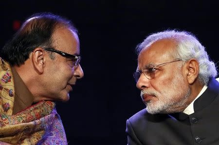 Prime Minister Narendra Modi (R) listens to Finance Minister Arun Jaitley during the Global Business Summit in New Delhi January 16, 2015. REUTERS/Anindito Mukherjee