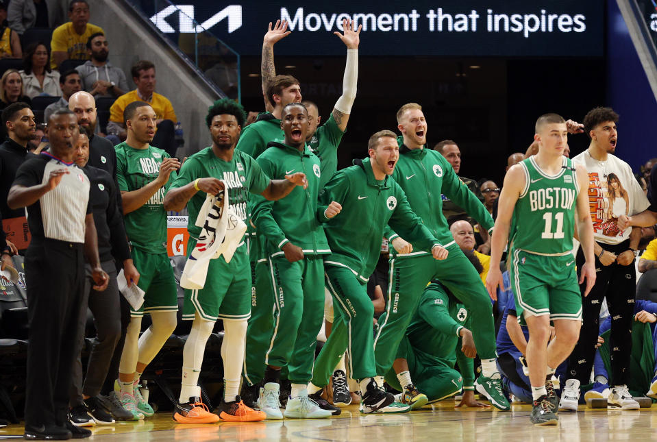 The Boston Celtics celebrate their fourth-quarter comeback against the Golden State Warriors in Game 1 of the NBA Finals. (Ezra Shaw/Getty Images)