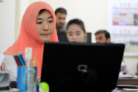 Reporters work at the office of Hushang, a Mandarin language weekly newspaper, in Islamabad, Pakistan June 9, 2017. REUTERS/Caren Firouz